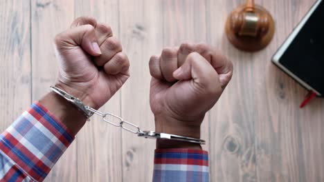 handcuffed man in courtroom setting