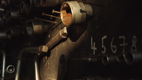 set of sockets hanging on a nail plate in an old car workshop