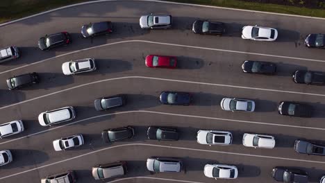 multiple lanes of cars and vehicles in bumper to bumper line revealed in top down drone shot