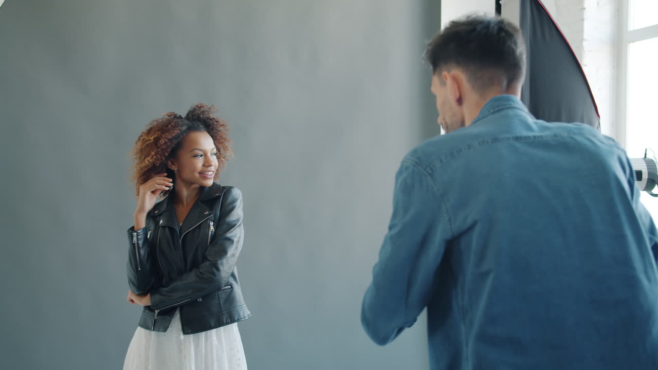 Fashion photoshoot in a studio with a model and a photographer