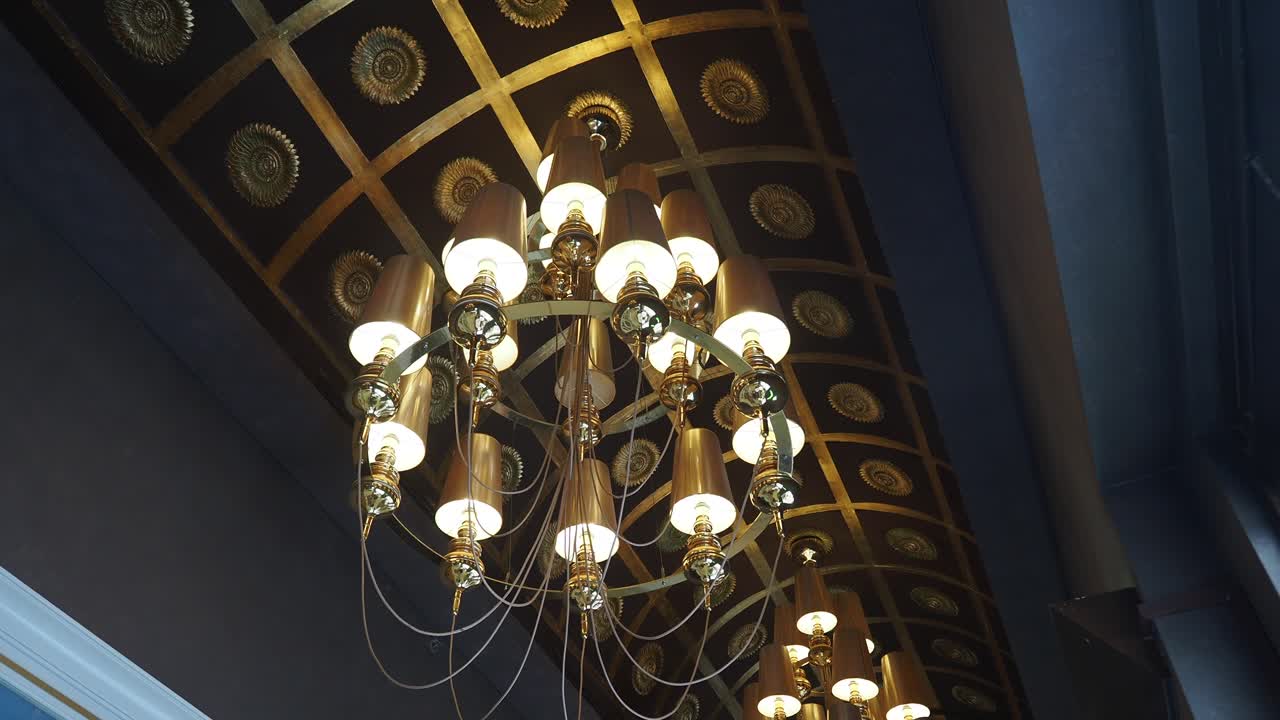 Ornate Gold Chandelier and Decorated Ceiling