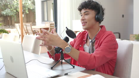 recording podcast, person wearing headphones speaking into microphone at home