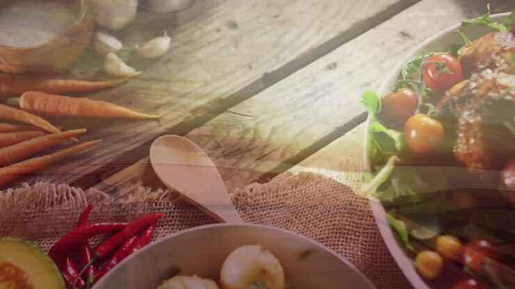 Animation of landscape over plates with food on wooden background