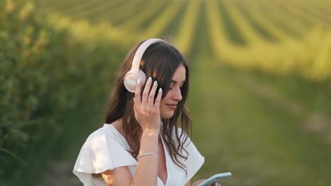 close-up portrait of a young woman listening to music on headphones and relaxing