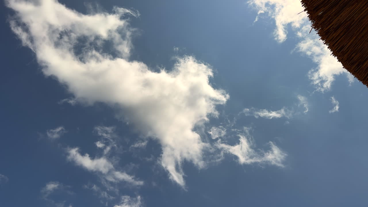 white clouds move quickly in the blue sky