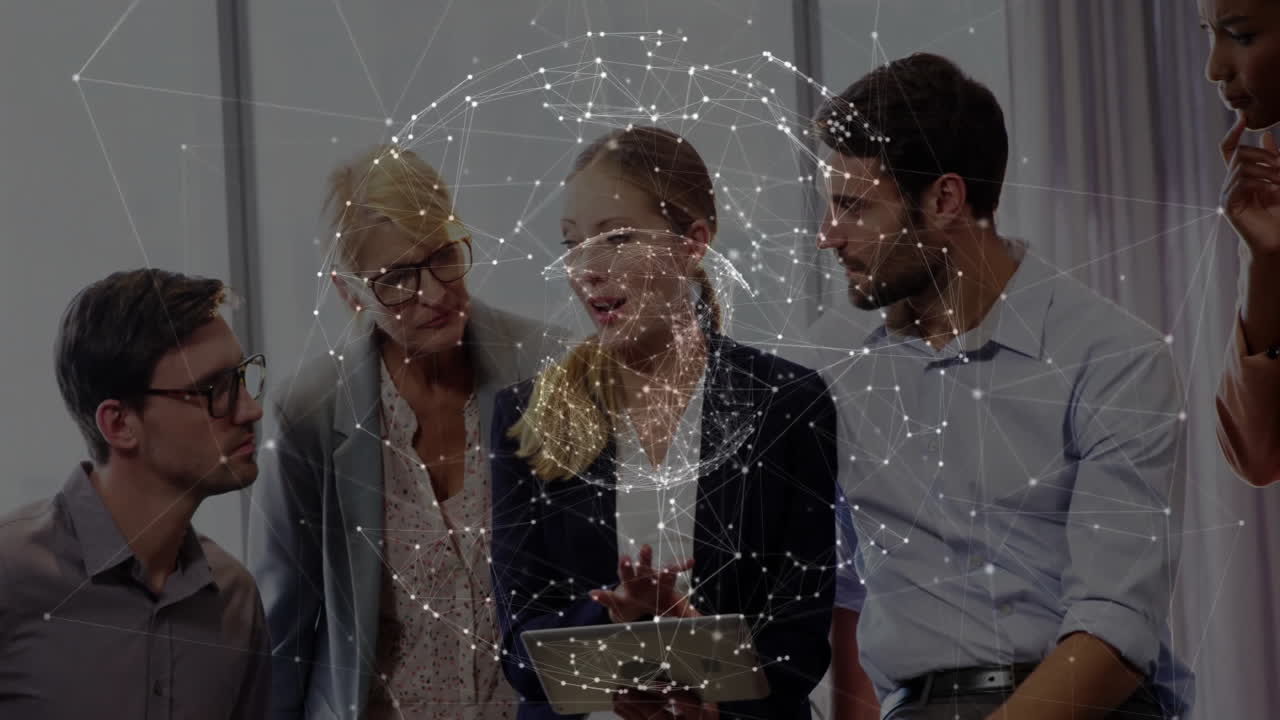 Business team collaborating around tablet in corporate meeting, displaying glowing network overlay