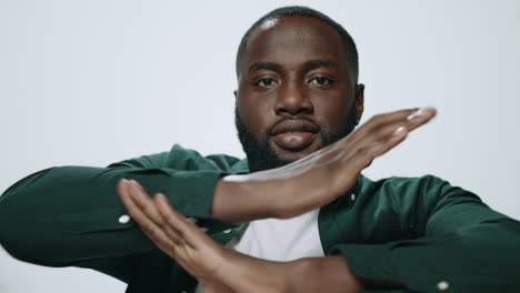 Portrait-of-bearded-african-american-man-dancing-on-light-background.