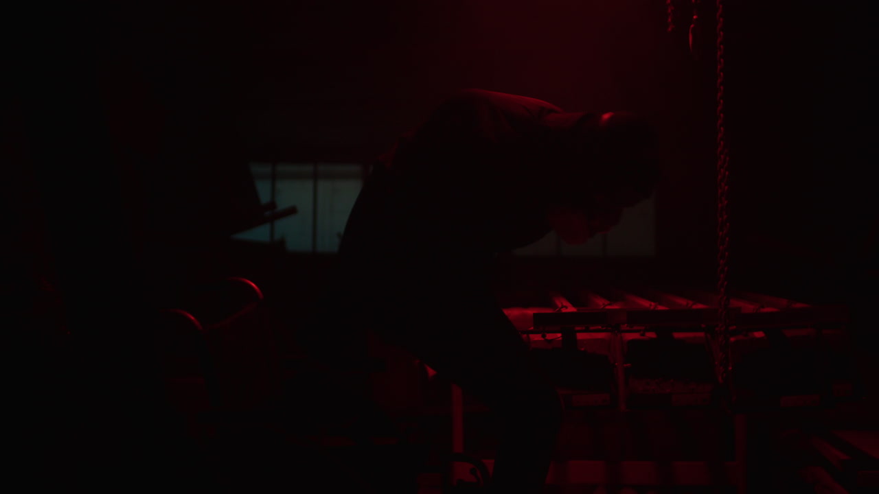 Person in Wheelchair in Industrial Setting at Night
