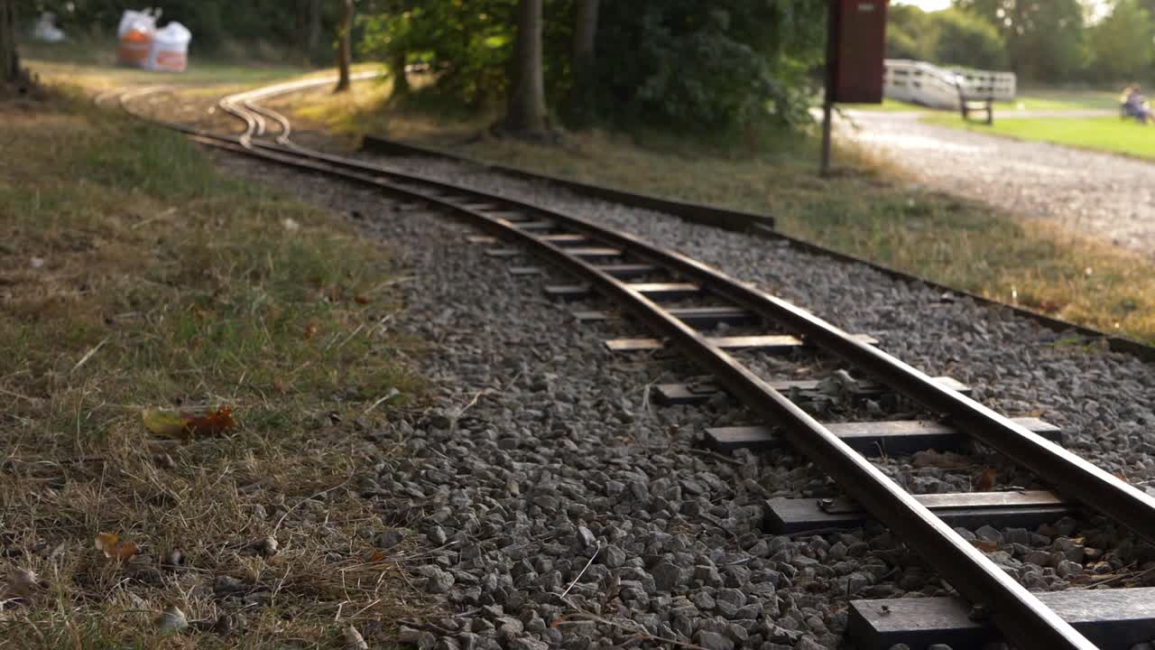 Monorail train track in park wide shot