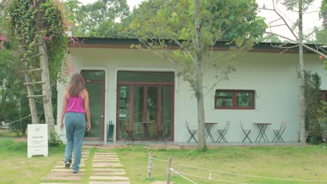 Woman-Walking-into-a-Garden-Coffee-Shop-in-Thailand