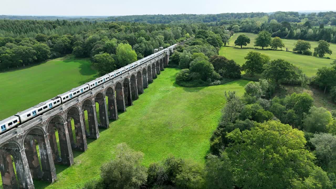 Stunning drone footage of Balcombe Viaduct, Sussex. A graceful train passes over the Victorian arches, framed by rolling green fields and timeless English countryside charm