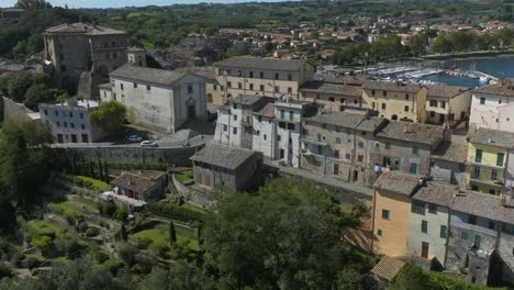 aerial around the rocca farnese castle and old town of capodimonte on lake bolsena, province of viterbo, italy