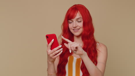 Redhead-girl-using-mobile-phone-typing-post-on-web-sms-message-browsing-addiction-of-social-networks