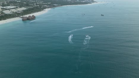 speedboats off coast of nungwi beach, zanzibar, aerial drone view