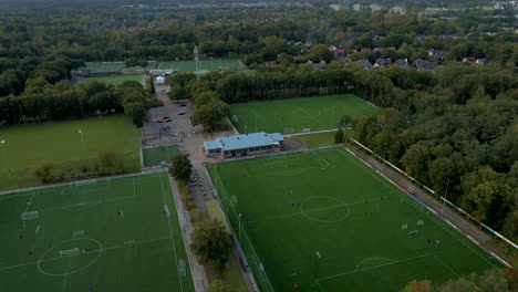 Aerial-of-busy-soccer-fields-early-in-the-evening