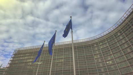 slow motion of eu flags waving as sunlight hits them gently