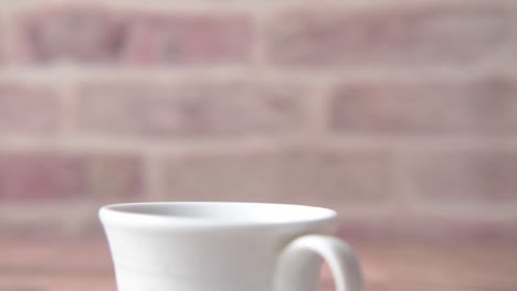 hand holding a power bank over a cup