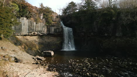 waterfall reveal with pull away in english countryside ingleton waterfalls trail yorkshire uk