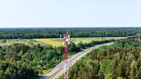 communication tower and green lithuania landscape, aerial orbit view