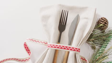 video of christmas place setting with cutlery and copy space on white background