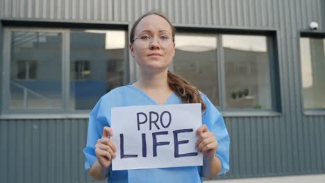 young nurse showing pro life sign, portrait view