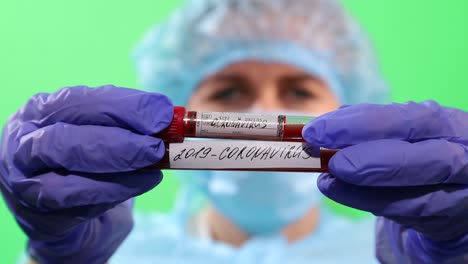 nurse in surgical mask with phone in hands on chromakey background, coronavirus concept