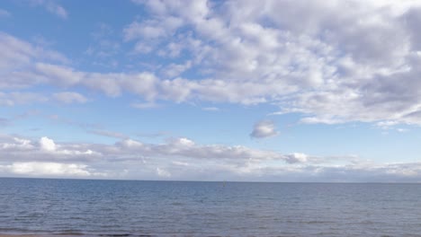 tourist-writing-AUS-letter-on-the-st-kilda-beach,-melbourne,-Australia