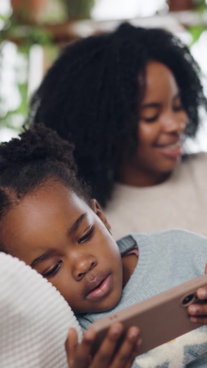 Young African American Girl Watching Smartphone While Relaxing at Home