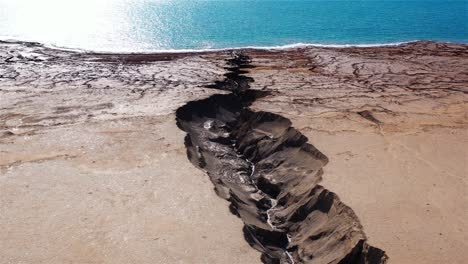dramatic sinkhole and fissure leading to the dead sea