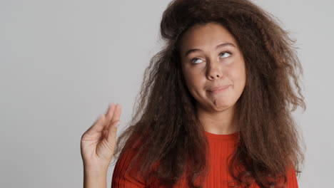 Caucasian-curly-haired-woman-getting-bored-of-people-talking.