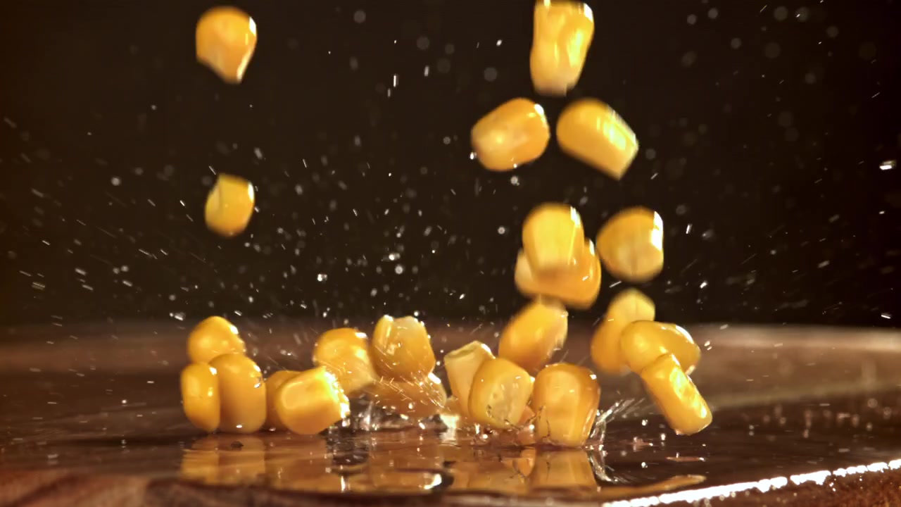Slow Motion of Corn Kernels Falling and Splashing on Wet Surface