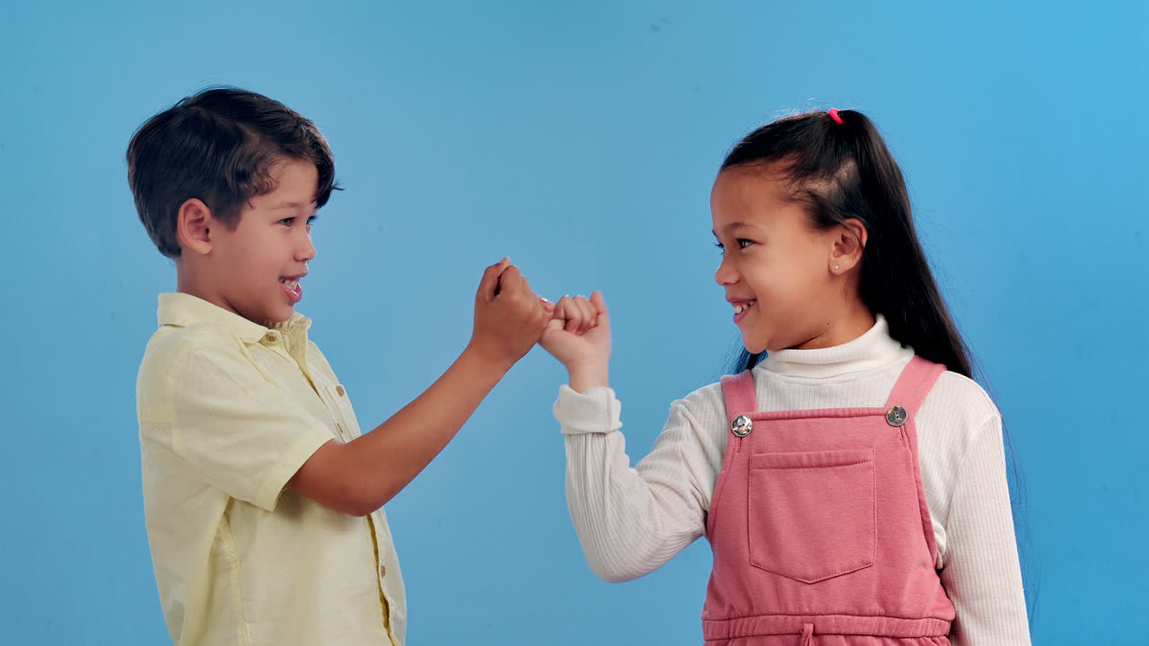 Two children making a pinky promise