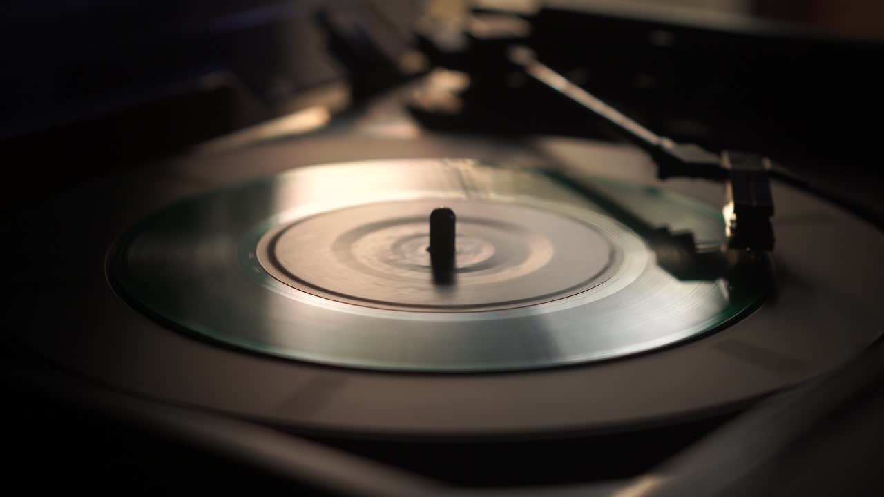 Starting Playback of Single Green Vinyl Record on Vintage Turntable, Close Up