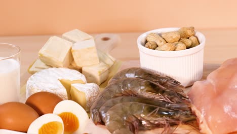 various protein-rich foods arranged on orange background