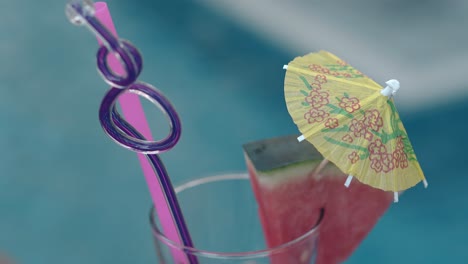 purple curved plastic stick stands inside shining glass