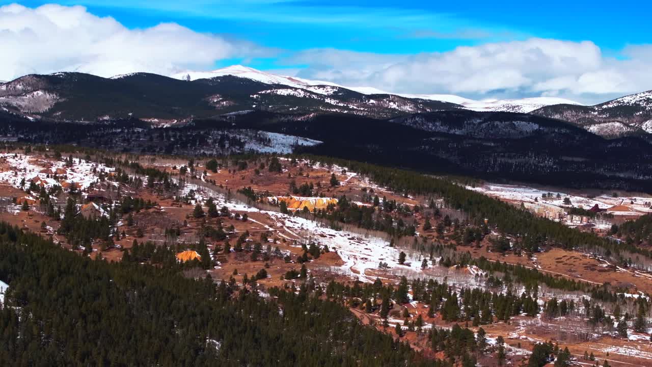 Gold mining Indian Peaks Nederland Eldora Historic Central City Parkway Black Hawk Casinos Idaho Springs aerial drone Colorado Gilpin County winter blue sky sunny clouds Rocky Mountains forward pan up