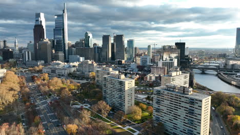 Aerial-of-Ben-Franklin-Parkway,-City-Hall,-Philly-skyline-with-dramatic-autumn-fall-colors