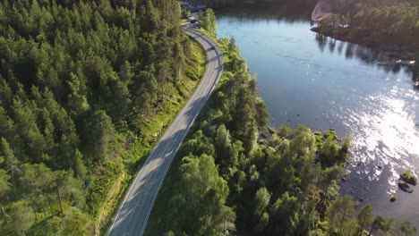 car passing by a lake in the evening