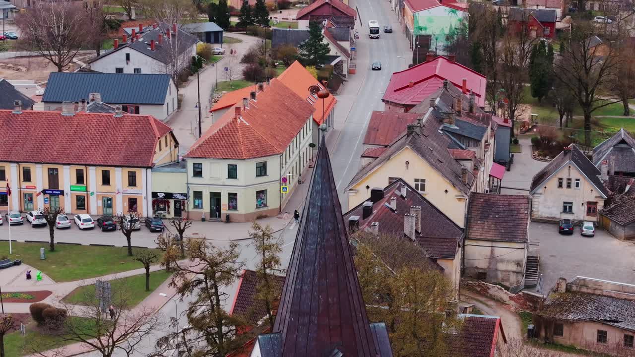 Saldus central plaza and rooftops unfold around church in orbiting motion