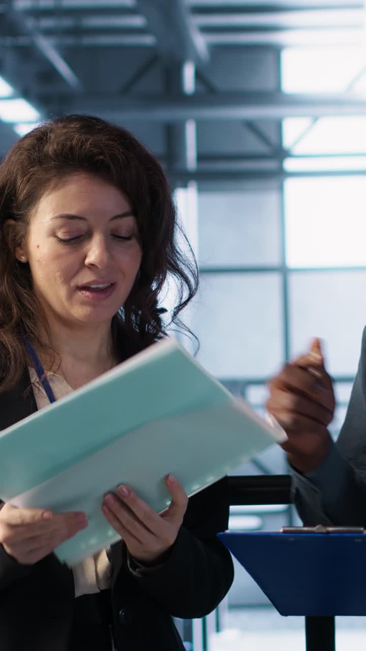 Vertical video Data center management executives reading paperwork files