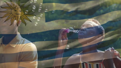 blowing bubbles with uruguay flag animation, people in sunny outdoor setting