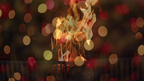 animation of flashing orange and red bokeh lights over flames in fireplace at home