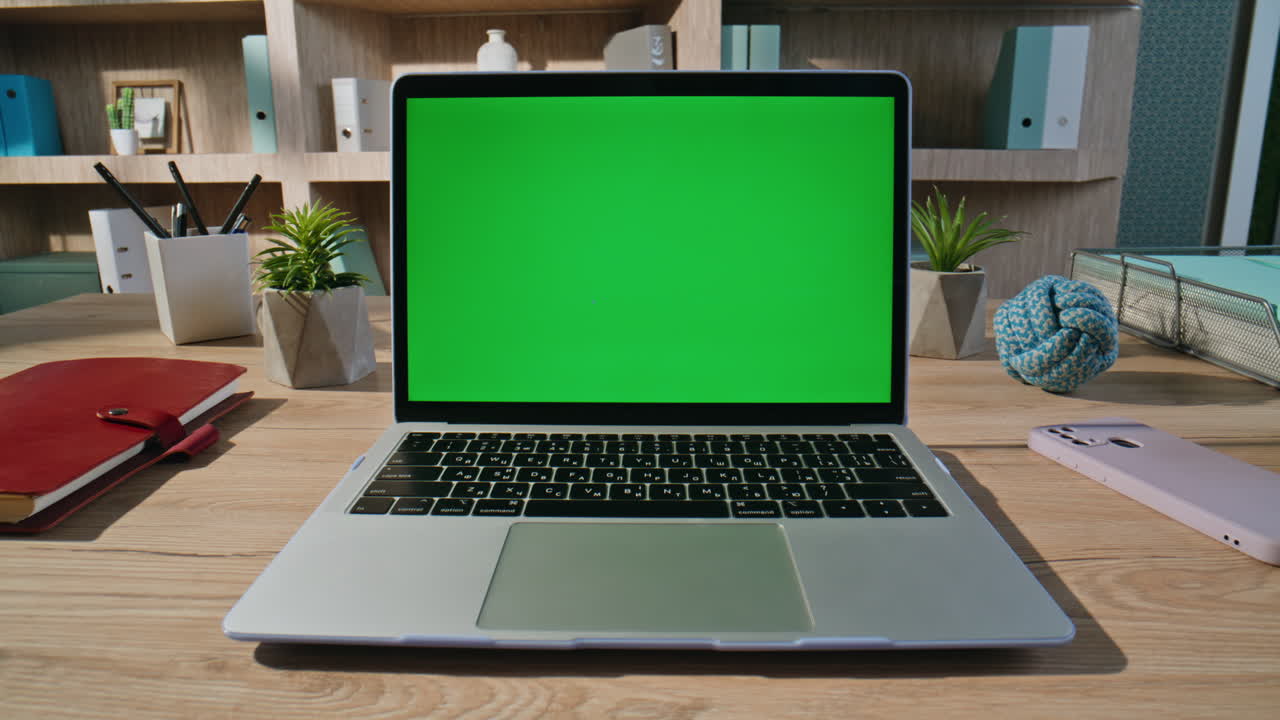 Primo piano di un manager che naviga su un’applicazione chroma key su un laptop seduto in un ufficio