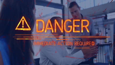 danger warning text animation over people discussing in modern office setting