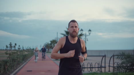 man running on a city path at dusk