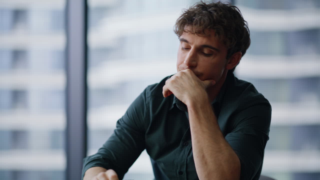 Business manager feeling tension examining paperwork at company office closeup