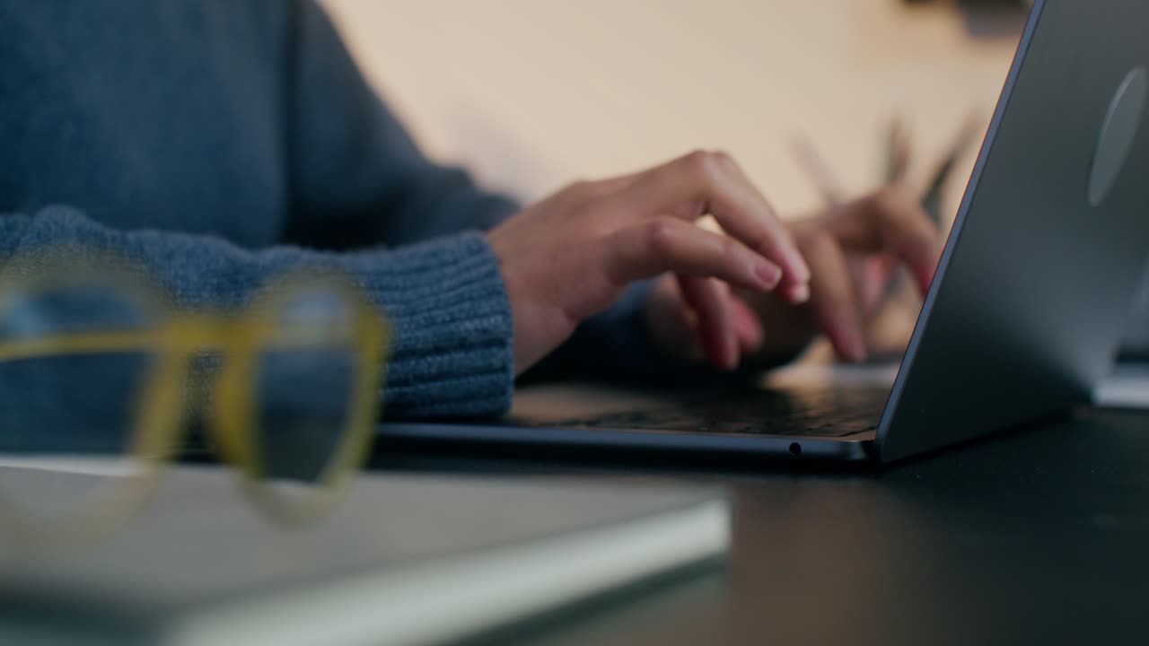 Woman typing on laptop at home