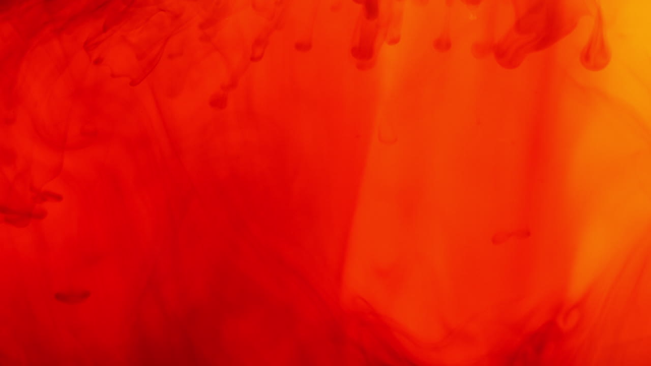 빨간색과 노란색 페인트 또는 염료가 색 배경에 물에 떨어지면 회전하는 다채로운 연기 배경을 만니다.