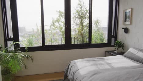 general view of modern bedroom with bed and window