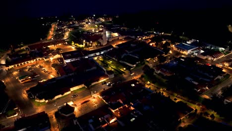 aerial view tilting over the illuminated guatavita village, night in colombia